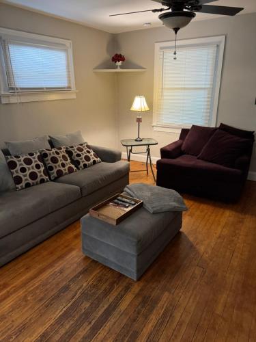 a living room with a couch and a table at Private downtown cottage in Indianapolis