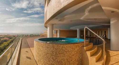 a swimming pool on the balcony of a building at Modern Cozy Seaview Entire Suites 118 Island Plaza in George Town