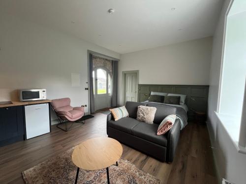 a living room with a couch and a table at Crossdrum Courtyard Accommodation in Oldcastle