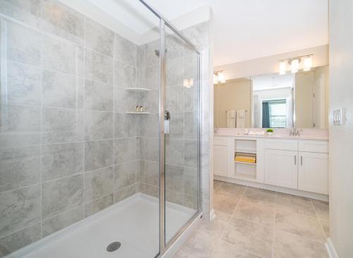 a bathroom with a shower with a glass door at 3171-204AZ STOREY LAKE, CONDO 2/2 LAKE VIEW in Kissimmee