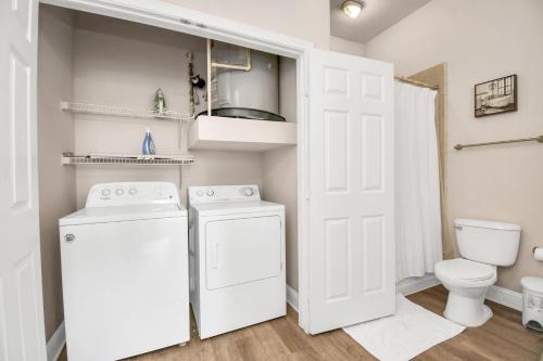 a white laundry room with a washer and dryer at Nrg Stadium Rodeo Unit in Houston