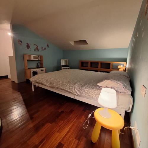 a bedroom with a bed and a wooden floor at La coccinella in Castelfiorentino