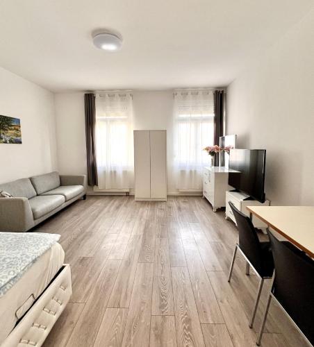 a living room with a bed and a couch at Wohnung am Rosengarten in Kehl am Rhein