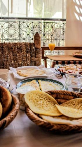 een tafel met broodmanden en eieren erop bij Riad Laly Tourisme Eclairé Le bijou de la medina in Marrakesh