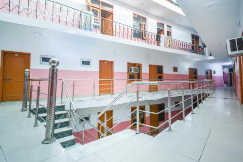 a hallway with a staircase in a building at SPOT ON 36686 Hotel Om Shanti Palace in Chandīgarh