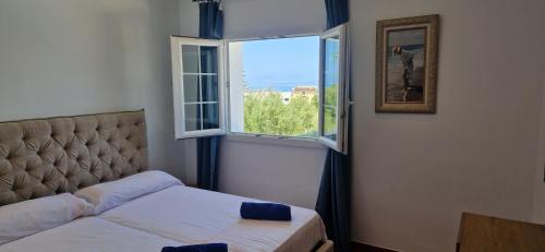 a bedroom with a bed and a window at Finca Ca Nostra, Charmante Villa, Großzügiger Pool & Meerblick in Llucmajor