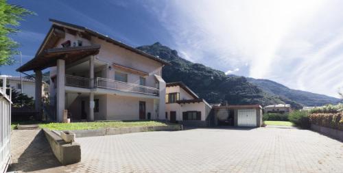 a house with a mountain in the background at Sonia Holiday Home - Camera Susan in Pont-Saint-Martin