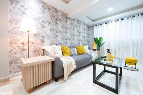 a living room with a couch and a table at Elegant, 2-Bedroom Retreat in Naco Central in Santo Domingo