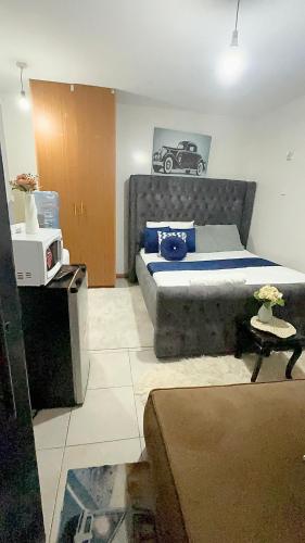 a bedroom with a bed with a car picture on the wall at fitbull homes in Nairobi