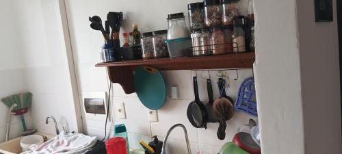 a kitchen with utensils hanging on a wall at Apartamento para cop 30 Belém Pará in Marituba