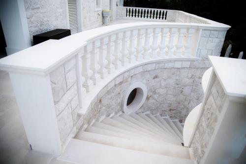 a stairway with a white stair case at Villa Angelina in Selva di Fasano