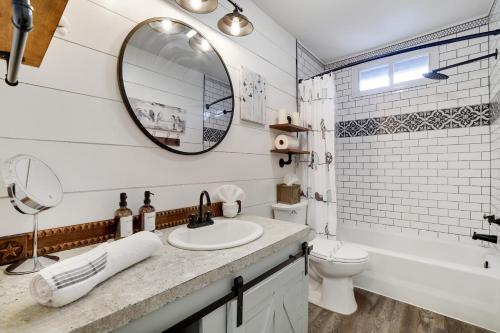 a bathroom with a sink and a toilet and a mirror at Pocono - Home away from home in Tobyhanna