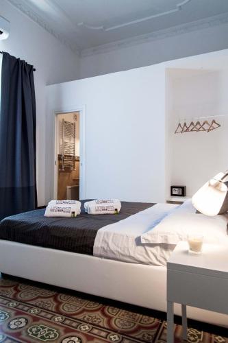 a bedroom with a large bed in a room at L'Opera Buffa in Palermo