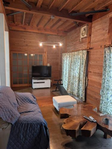 a living room with a couch and a coffee table at Kenny's house in Joso