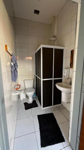 a bathroom with a toilet and a sink at Hostel Beira Mar in Ilha Comprida