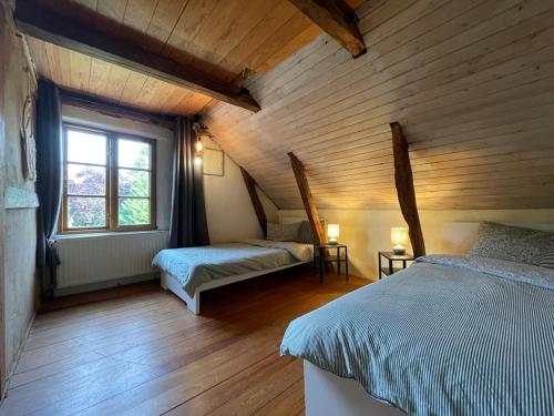 a bedroom with two beds in a room with wooden walls at Deichliebe ÖKOlogisch in Winsen Luhe