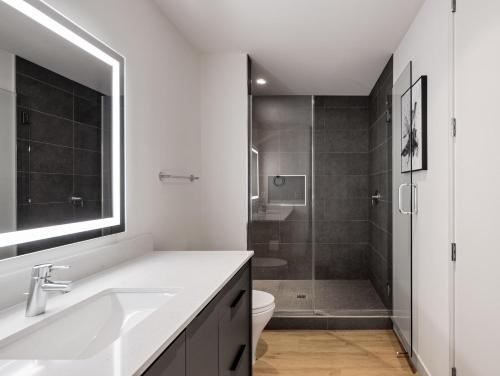 a bathroom with a sink and a toilet and a shower at Thunderbird - 4 Units - Jacuzzi - In Old Town in Scottsdale