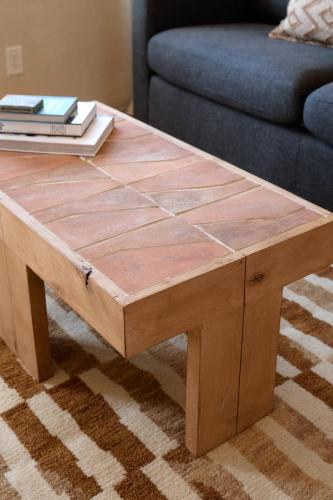 a wooden coffee table in front of a couch at Los Bungalows in Imperial Beach