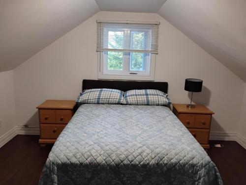 a bedroom with a bed and a window at Serene Getaway Nordic Spa , Sauna, Nature & Pool in Rawdon