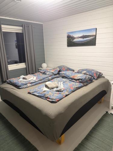a bed with a blanket on it in a bedroom at Huset nært blåisvannet 