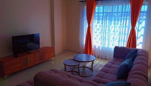 TV a/nebo společenská místnost v ubytování Zenaworld Stay Rongai