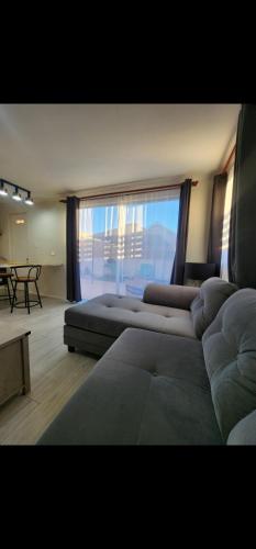 een woonkamer met 2 bedden en een groot raam bij Casa nueva amoblada in Ovalle