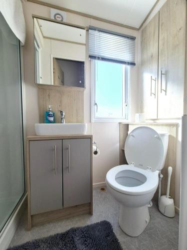 a bathroom with a white toilet and a sink at ABI Beverley - Dog friendly, Family friendly Whitstable in Seasalter