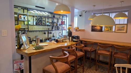 a bar in a restaurant with stools at a counter at Freyja Café Bistró - Hostal Boutique in Bogotá
