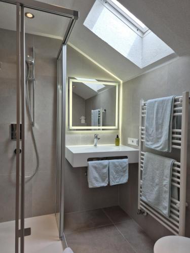 a bathroom with a sink and a shower and a mirror at Garbershof in Sölden