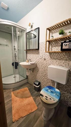 a bathroom with a shower and a toilet and a sink at Burgblick in Nossen