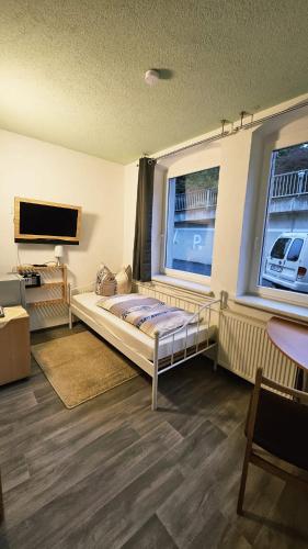 a bedroom with a bed and a large window at Burgblick in Nossen
