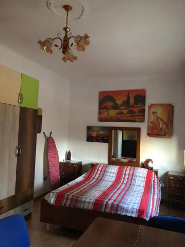 a bedroom with a bed and a mirror and a ceiling at Rose in Tirana