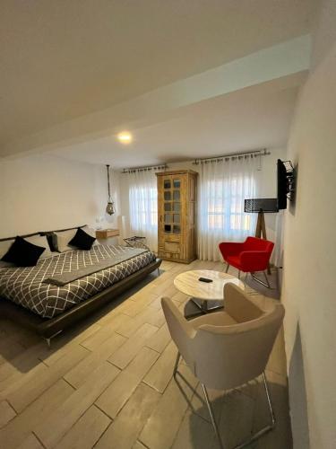a bedroom with a bed and a chair and a table at NIDO Hotel in San Miguel de Allende