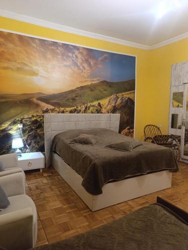 a bedroom with a large painting on the wall at Gamsakhurdia Street in Borjomi