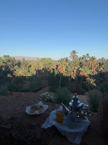 a table with a tea kettle and a plate of food at kasbah panorama chez Alilouch in Nkob