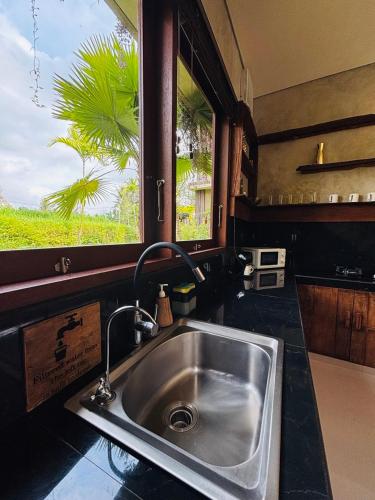 a kitchen with a sink and a window at ElForest Villa Ubud, Payangan in Payangan