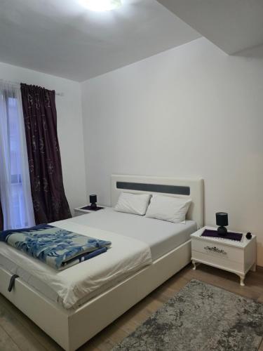 a bedroom with a white bed and a window at Flat Rafailovic One minute to Beach in Budva