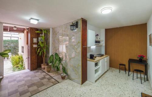 a kitchen with a counter and some plants in it at Breezot Yam in Nahariyya