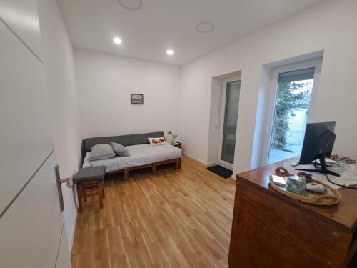 a living room with a couch and a desk with a computer at GAG Apartment in TRAM zone with FREE PARKING in front of the house in Zagreb