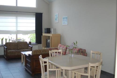 a living room with a table and a couch at Vino Grando Cottage in Odiliapeel