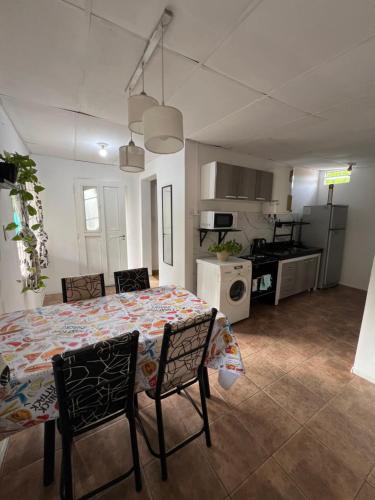 a kitchen and dining room with a table and chairs at La casita the Aye in Villa Carlos Paz