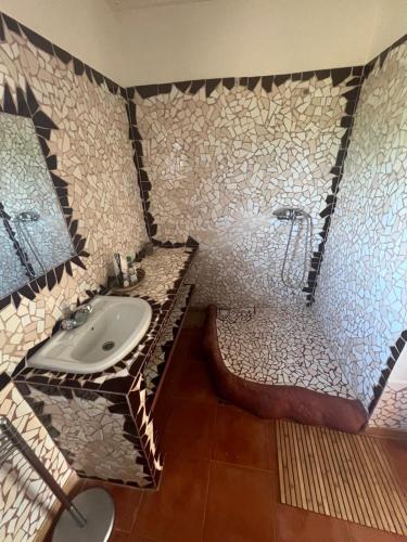 a bathroom with a sink and a shower at Casa Jujube - Guest House in Dakar