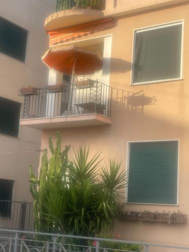 a building with balconies and plants in front of it at Casa Terrazzino - 50 m dal mare in Bordighera