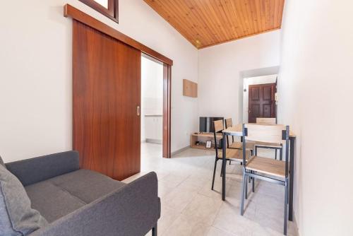 a living room with a couch and a table at João Loft Ii by Mth in Campanário