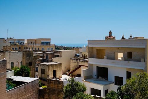 a view of a city with buildings at Villetta Dorata - Gozo Holiday Home with Terrace & Field View in Qala