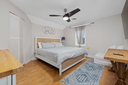 a bedroom with a bed and a ceiling fan at Vintage West Central Apt Walkable Free Parking! in Fort Wayne