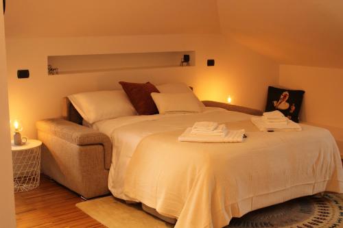 a bedroom with a bed with towels on it at Suite Cascina Balocco in Neive