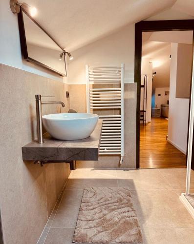 a bathroom with a bowl sink on a counter at Suite Cascina Balocco in Neive