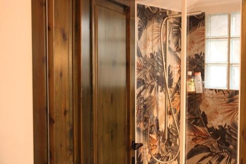 a wooden door in a room with a wallpaper at Suite Cascina Balocco in Neive