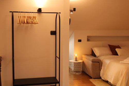 a bedroom with a bed and a sliding glass door at Suite Cascina Balocco in Neive